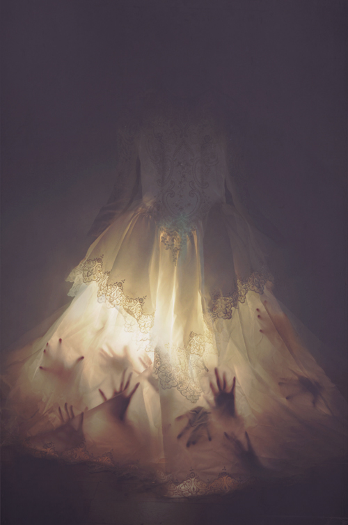 hands seen through illuminated lace dress