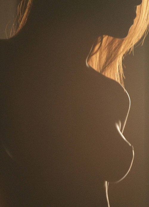 silhouette of nude woman with auburn hair