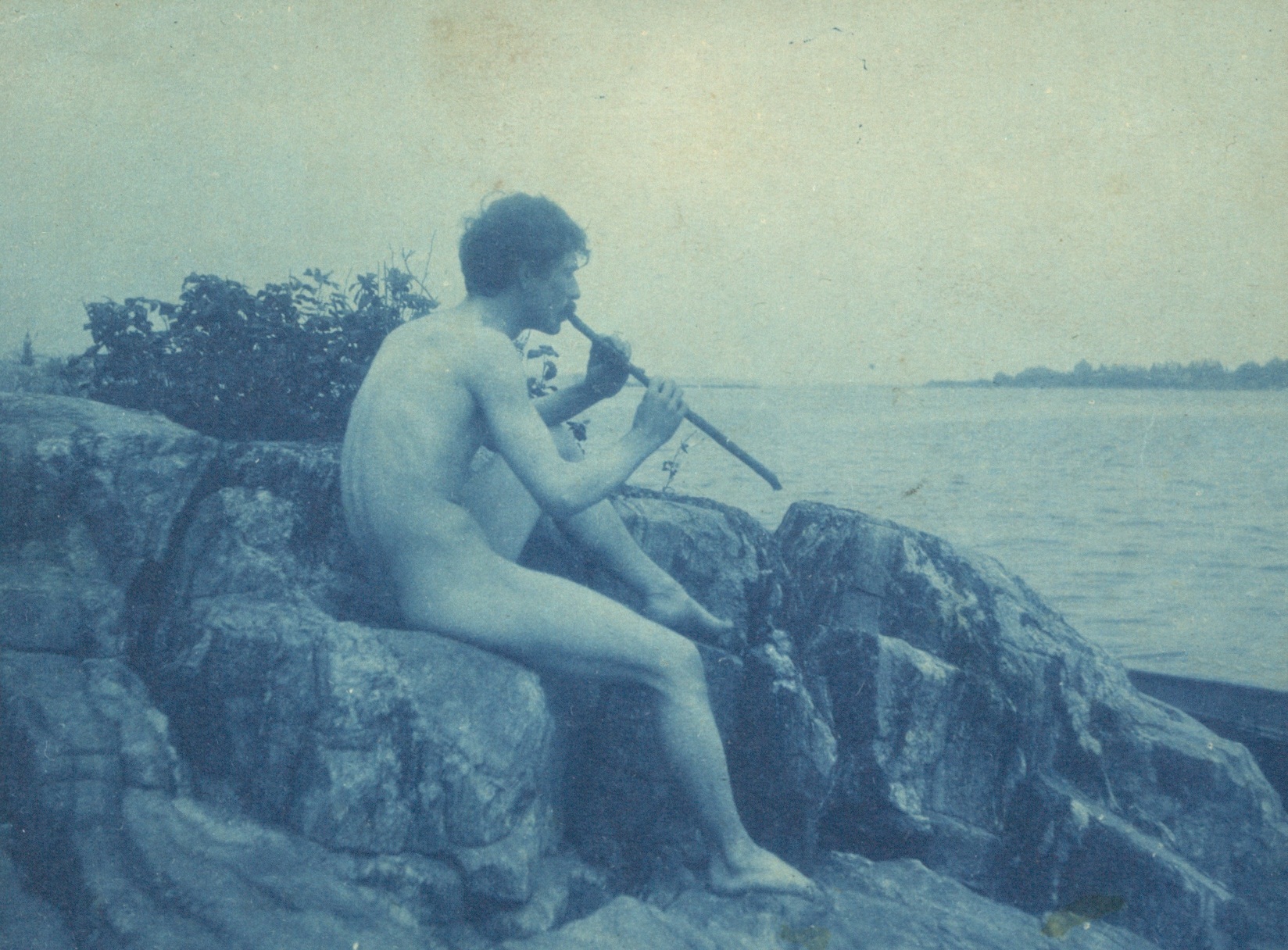 Cyanotype photographh of a nude man playing pipe by Frances Benjamin Johnston