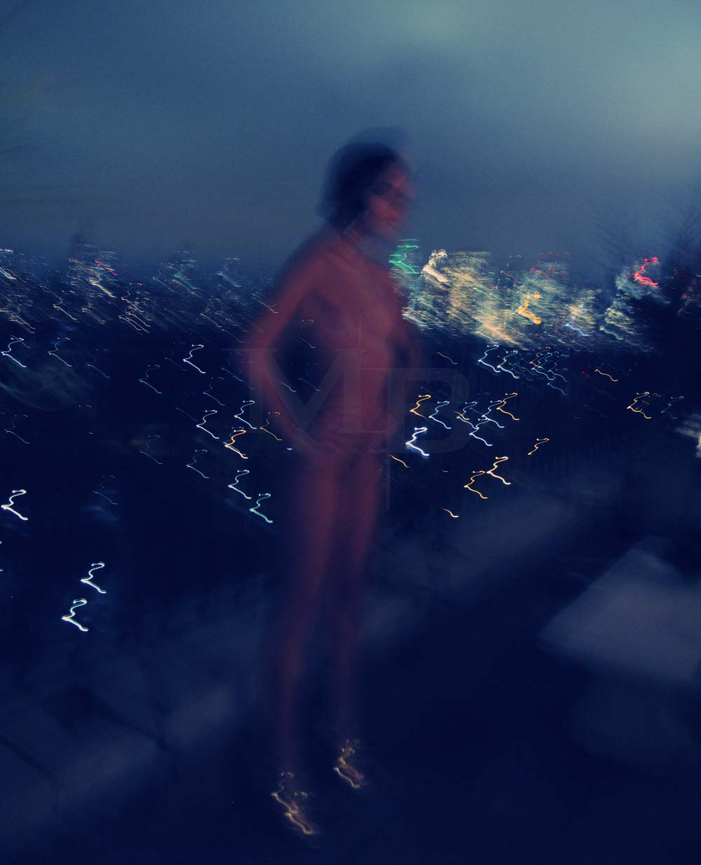 long exposure with light streaks, of nude woman and cityscape